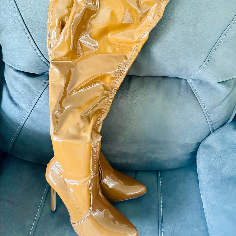 Brand new thigh high tan boots . Size 7 women's boot. Never worn